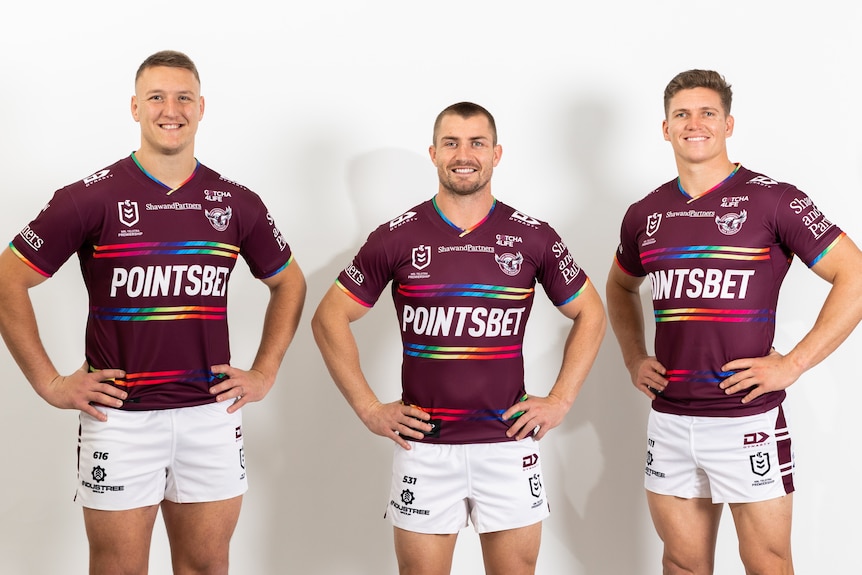 Three Manly players wearing the pride jersey