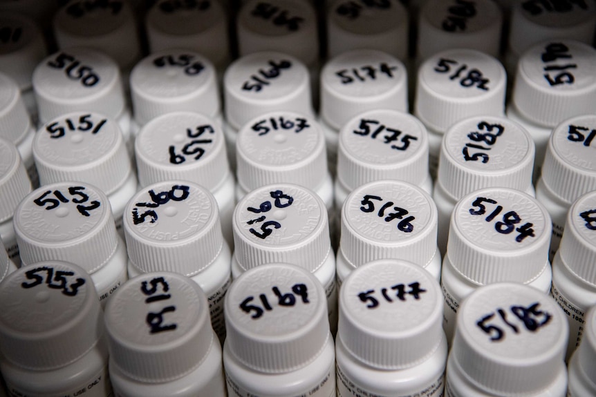 Bottles of pills with a number on the lid