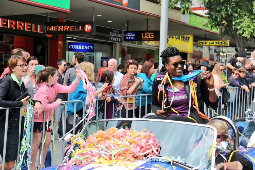 Goal shooter Romelda Aiken soaked up the parade on top of a vintage car.