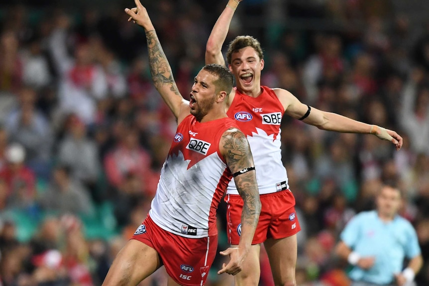 Lance Franklin takes off in celebration after kicking a goal.