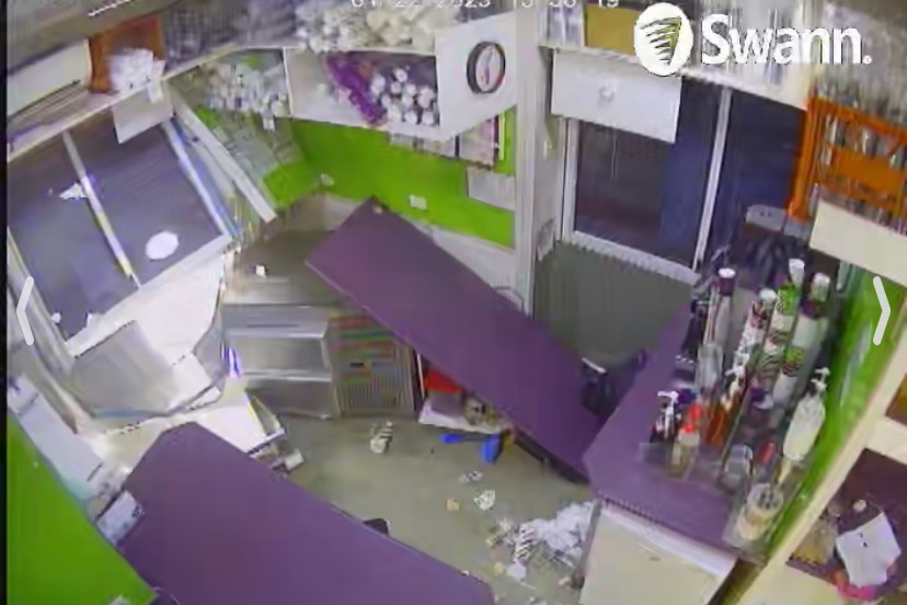 A CCTV image shows a complete mess inside of a takeaway store with items broken.