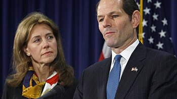 New York Governor Eliot Spitzer stands next to his wife Silda Wall Spitzer as he announces his resignation at his office in N...