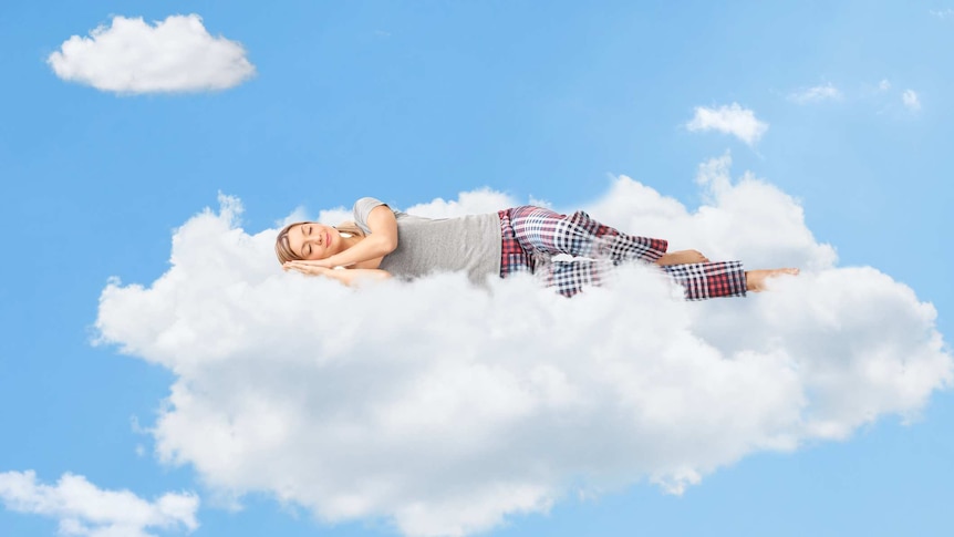 woman in pyjama pants and t-shirt sleeping on floating cloud