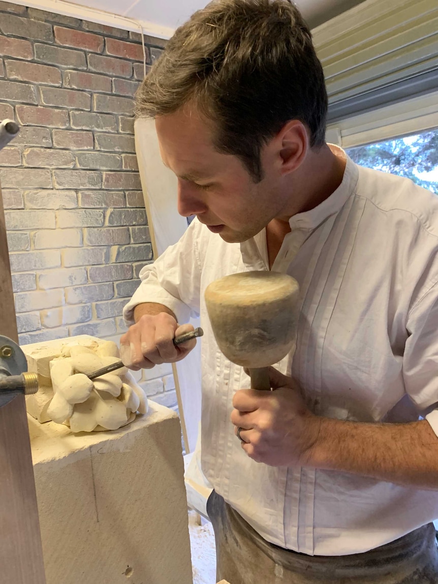 Stonemason Christian Frenzel working with tools.