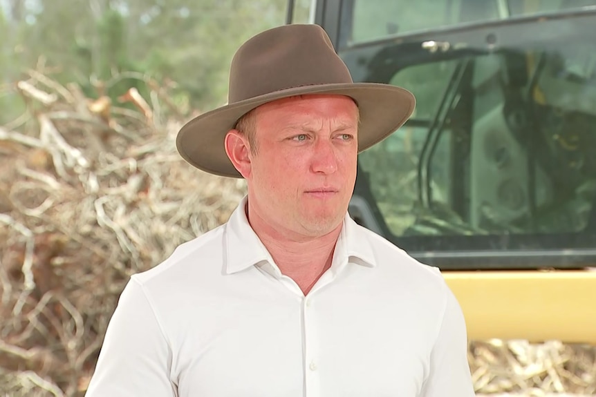 Deputy Premier Steven Miles wears a hat and white shirt