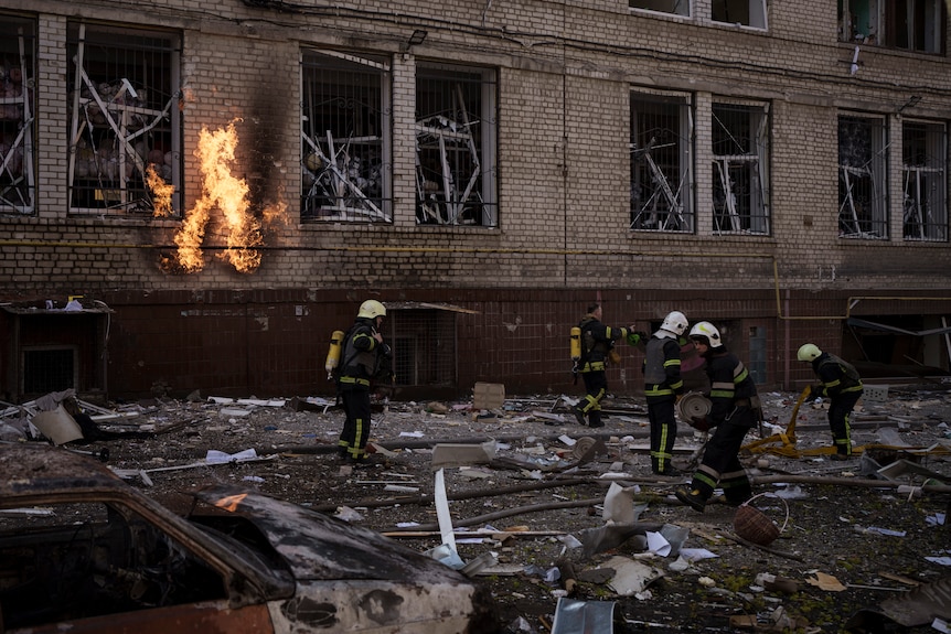 Firefighters work to extinguish multiple fires after a Russian attack