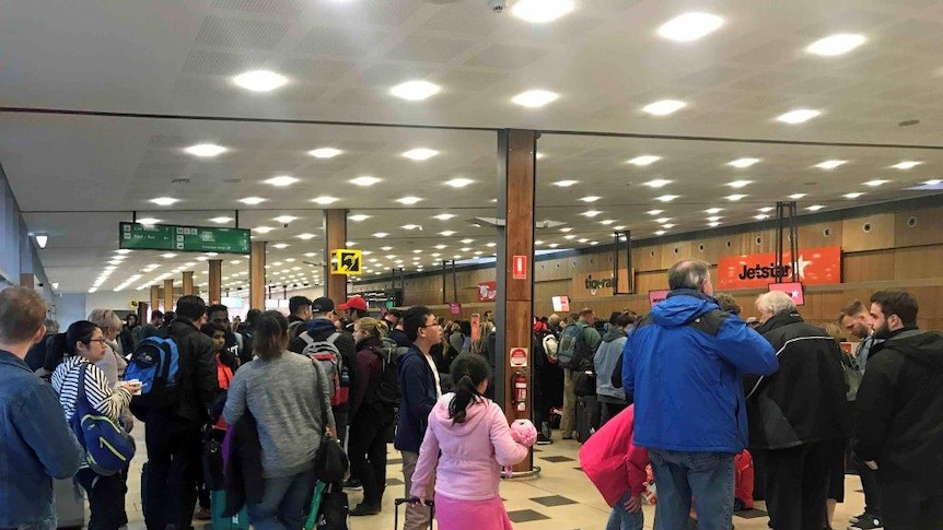Passengers try to check in at Hobart airport