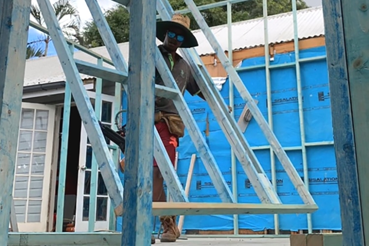 Jahangir Alam on a building site working as an apprentice carpenter