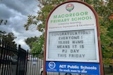 A sign outside Macgregor Primary School advertising an upcoming 'PJ Day'.