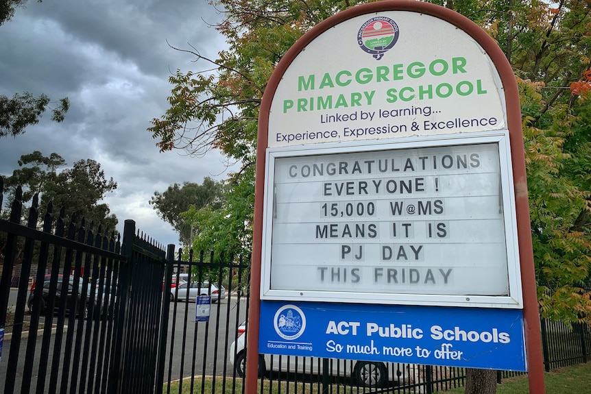 A sign outside Macgregor Primary School advertising an upcoming 'PJ Day'.