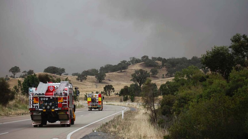 Fire trucks drive on the closed Hume Highway