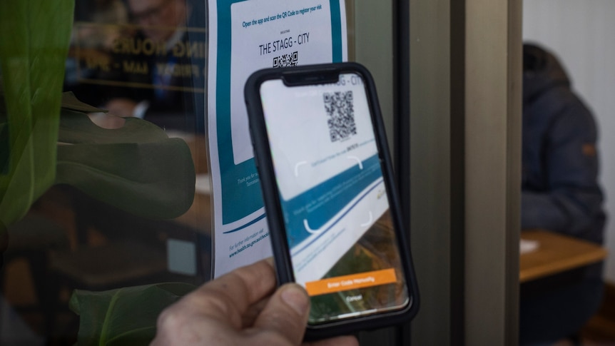 Person uses their phone to scan a QR image.