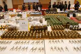 Thai military officers inspect weapons seized since the May 22 military coup at the Bangkok military HQ