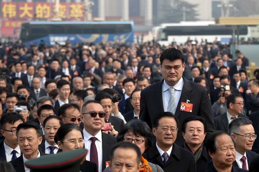 Former NBA basketball player Yao Ming arrives at the Great Hall of the People. He is much taller than the other delegates.