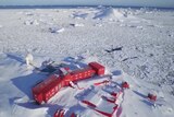 A collection of red buildings on white ice