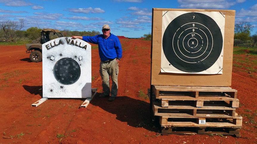 A man stands with a metal gong