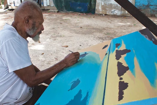 Torres Strait Islander man painting