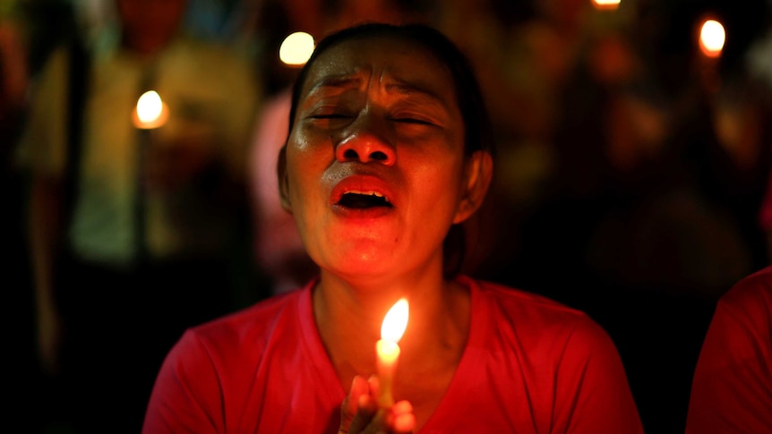 A woman weeps after an announcement that King Bhumibol Adulyadej has died.