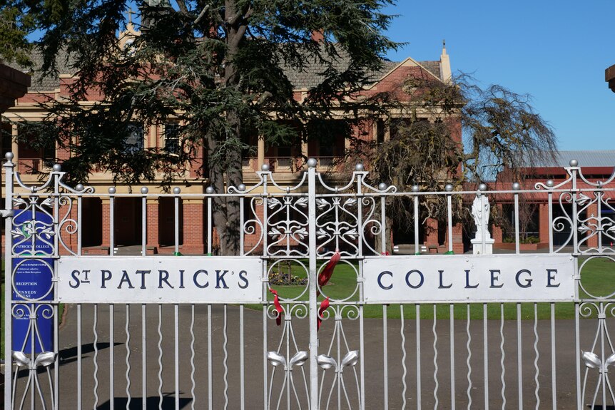 A school building with fence that says St Patricks college out the front