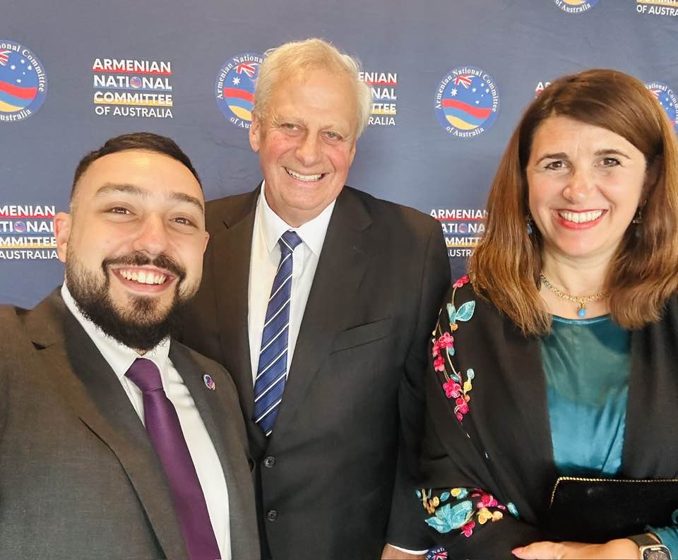 Three people in front of a banner reading 'Armenian National Committee of Australia'