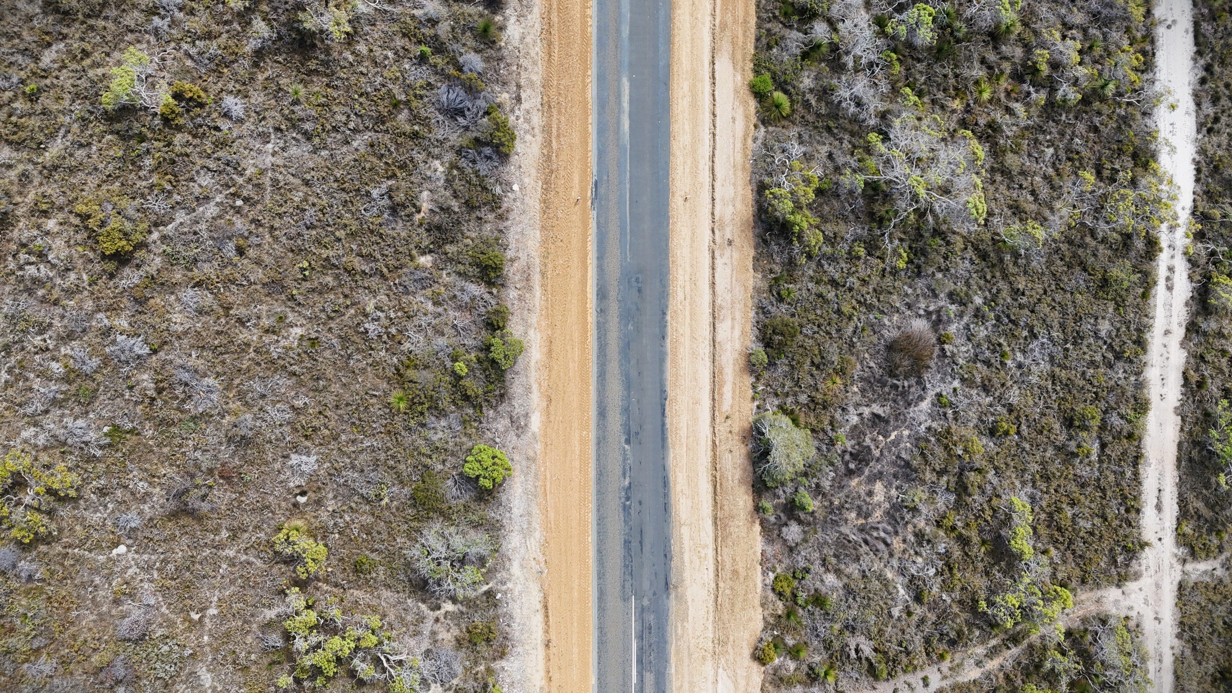 WA's South Coast highway from above, showing unmarked areas and rough edges. 