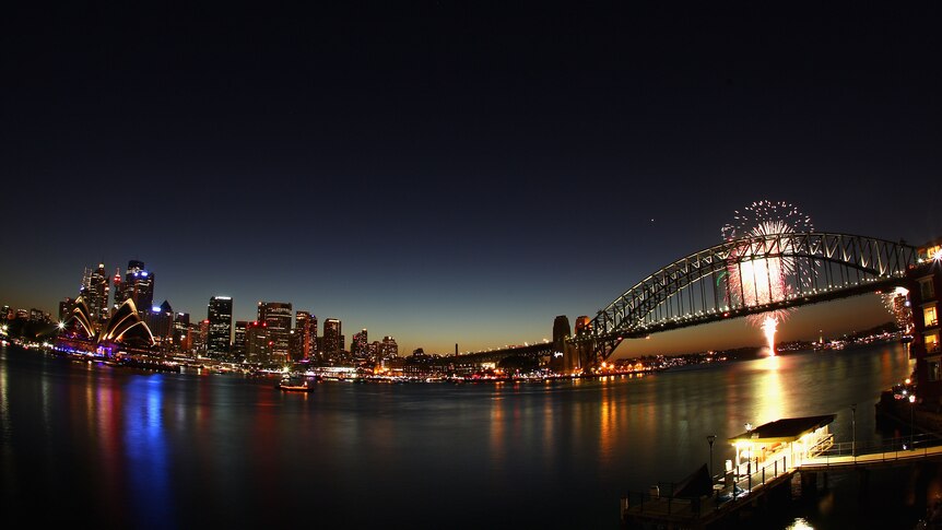 Fireworks light up the skyline over Sydney Harbour