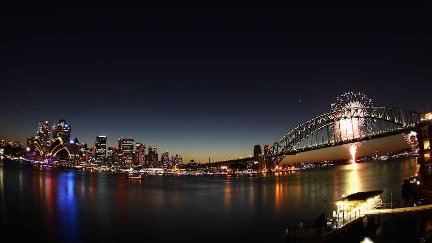 Fireworks light up the skyline over Sydney Harbour