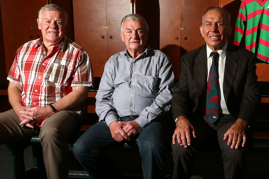 Bob McCarthy, George Piggins and John Sattler pose for a photo in the changing rooms of the SCG in 2014.