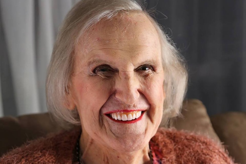 Smiling older woman with red lipstick