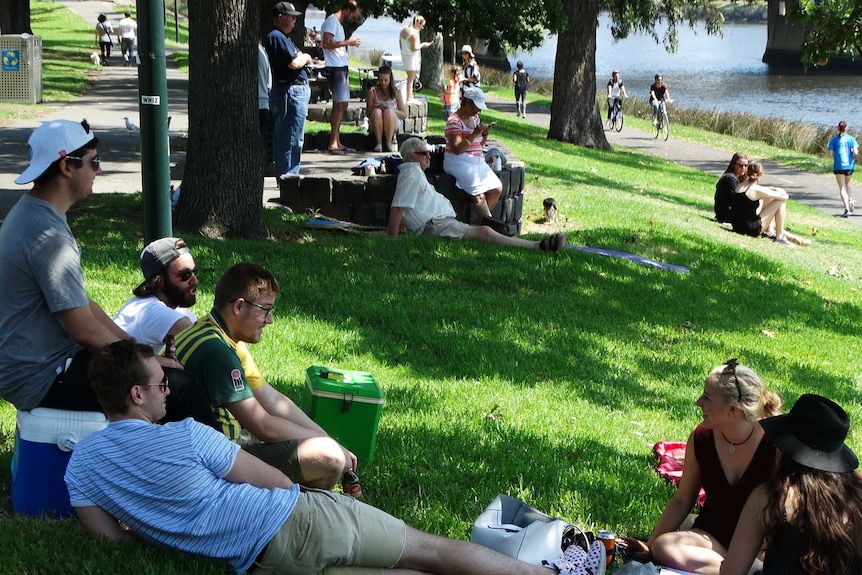 People celebrate Australia Day with a picnic beside the Yarra River in Melbourne