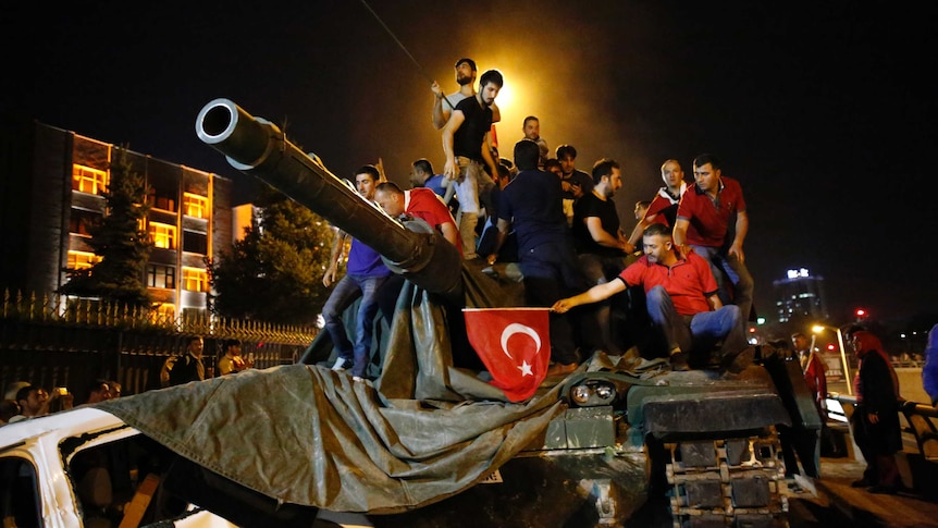 People stand on a tank during the night of the attempted military coup in Turkey.