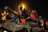 People stand on a tank during the night of the attempted military coup in Turkey.