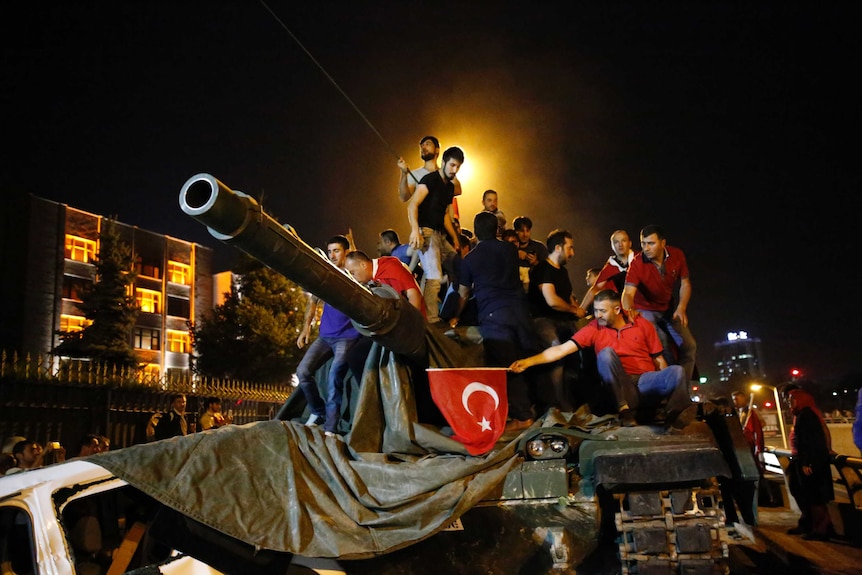 People stand on a tank during the night of the attempted military coup in Turkey.