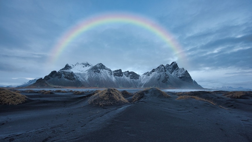 Rainbow viewed across an icy landscape