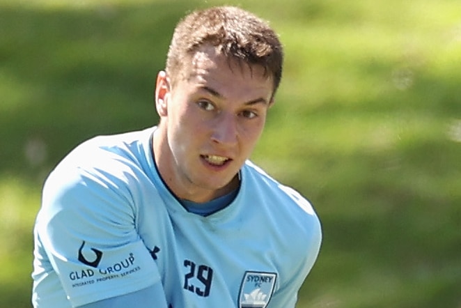 Anton Mlinaric kicks a soccer ball with his left foot, his right leg bent behind him