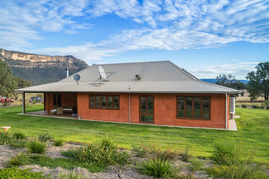 A picture of a new one-storey home in a rural setting.