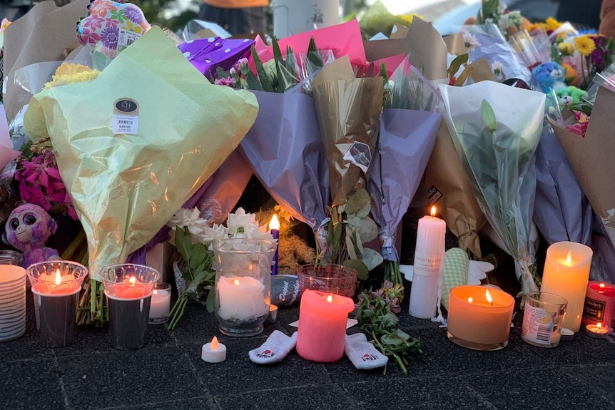 Candles, flowers, baby booties and teddies at a vigil for Katherine Leadbetter, who was pregnant, and Matthew Field.