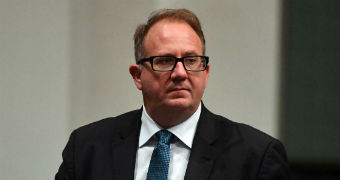 David Feeney holds a glass of water during Question Time in the House of Representatives.