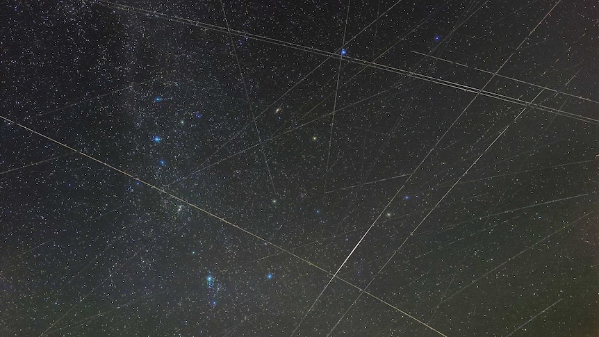 An image of the Perseids meteor shower with lines made by satellites.
