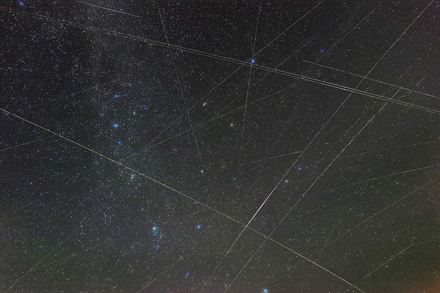 An image of the Perseids meteor shower with lines made by satellites.