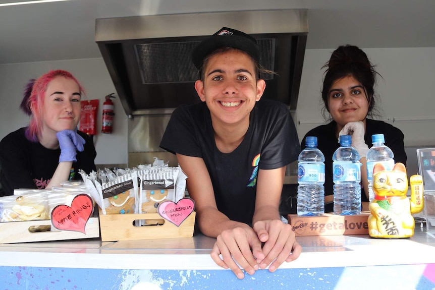 Teenagers Lily, Raymond and Malaika working in the Good Grub Club food van.