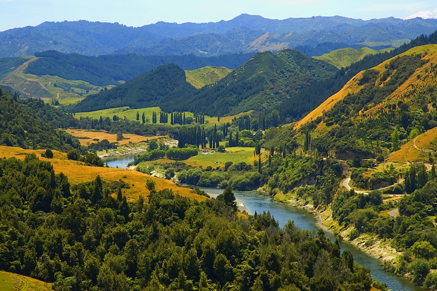 A wide shot of a river meandering through paddocks.