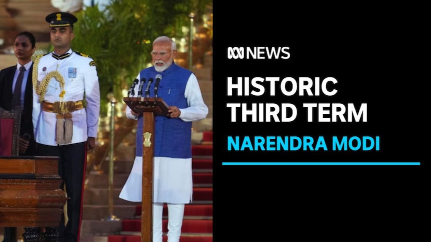 Historic Third Term, Narendra Modi: Narendra Modi standing at podium speaking into microphone next to soldier in formal uniform