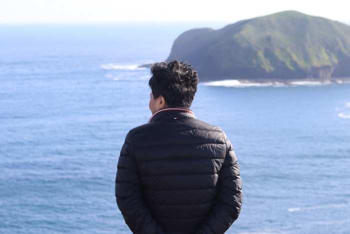 Mr Lu looking out to sea at Cape Grim.