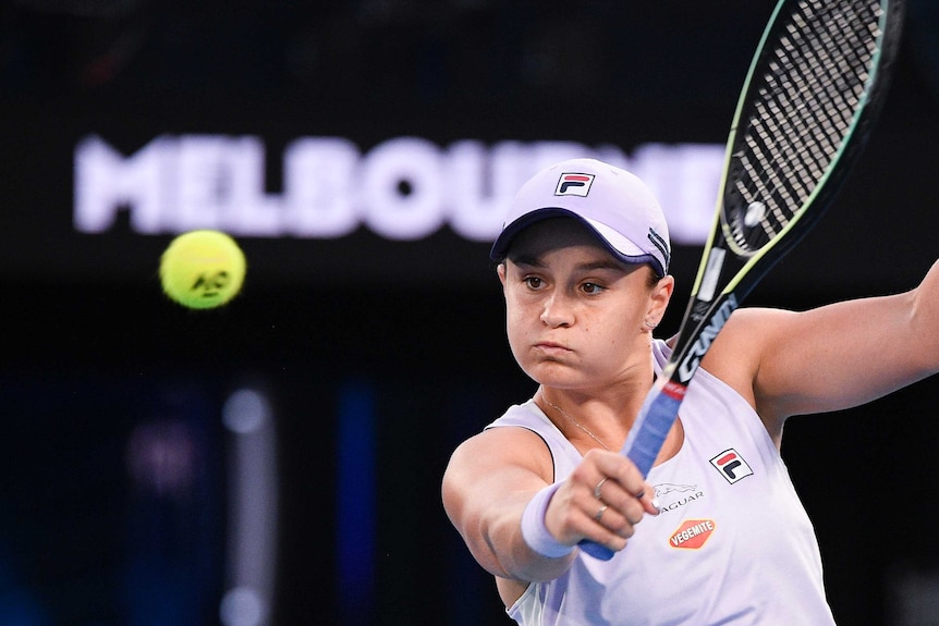 A tennis player looks straight at the ball as she prepares to hit a backhand during a match.