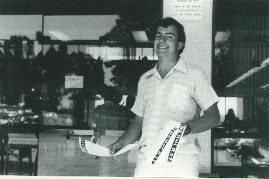 A black and white photo of a youthful Tony Abbott handing out flyers