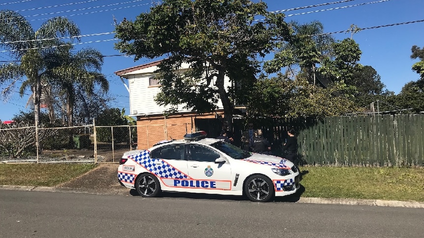 A police car outside a Logan house where the elderly woman died overnight.