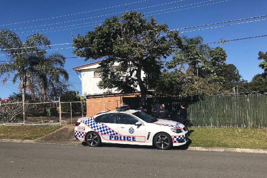 A police car outside a Logan house where the elderly woman died overnight.