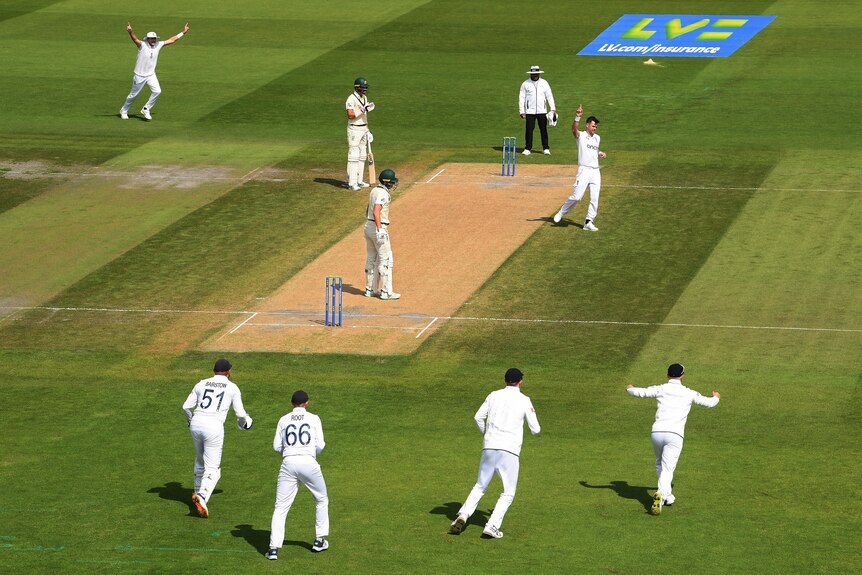 England celebrates a wicket on day two of the fourth Ashes Test at Old Trafford.