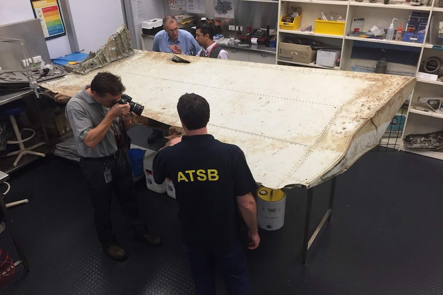 ATSB officers examining debris